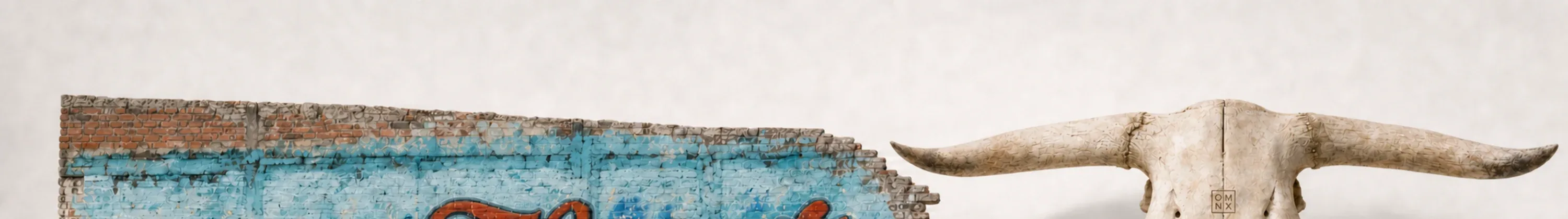 A close crop of weathered brick and hand-painted color, texture only.